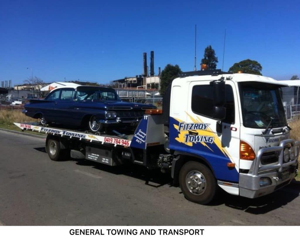 Tow Truck Hauling a Blue Classic Car on a Sunny Day — Fitzroy Towing & Transport in Parkhurst, QLD