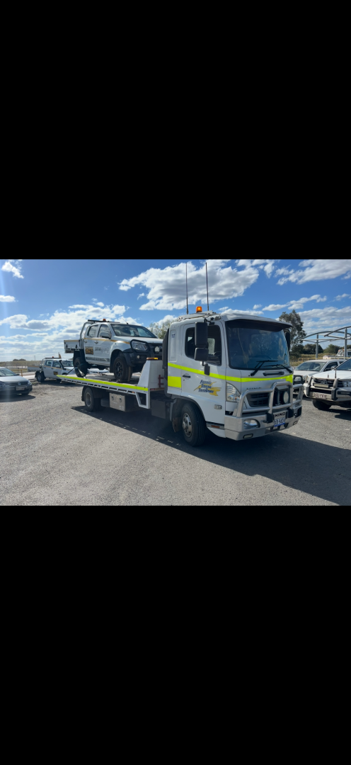 A white tow truck carrying a white car on a sunny day.— Fitzroy Towing & Transport in Parkhurst, QLD