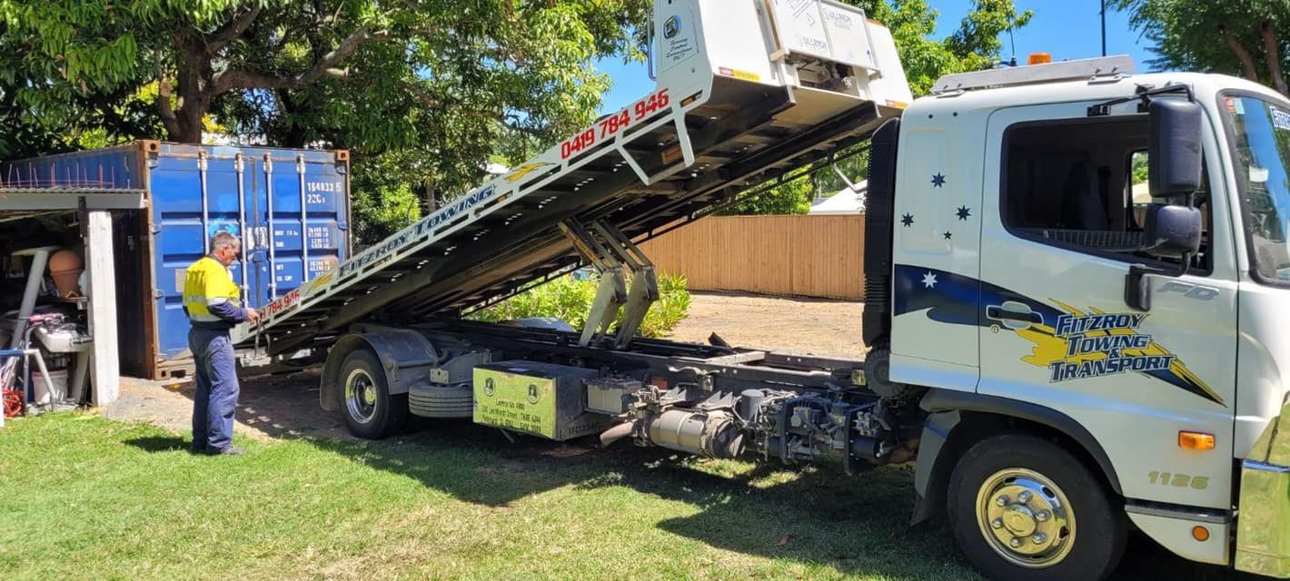 A Tow Truck With Its Bed Raised, Parked — Fitzroy Towing & Transport in Biloela, QLD