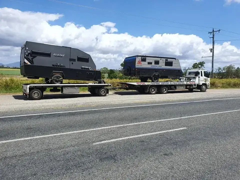 Two Rvs on Flatbed Trucks Parked on a Roadside — Fitzroy Towing & Transport in Emerald, QLD