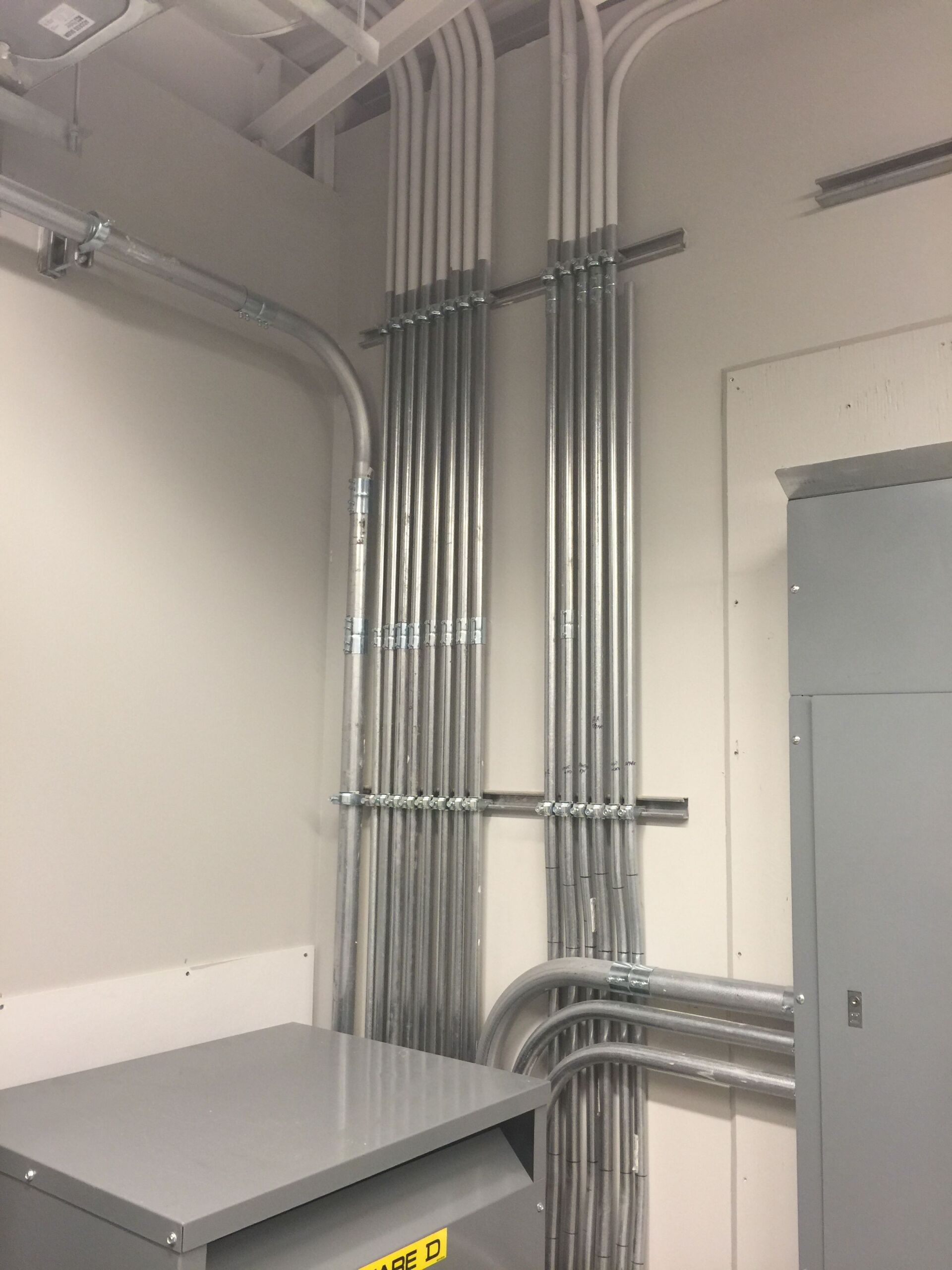 A room with a lot of electrical wires hanging from the ceiling