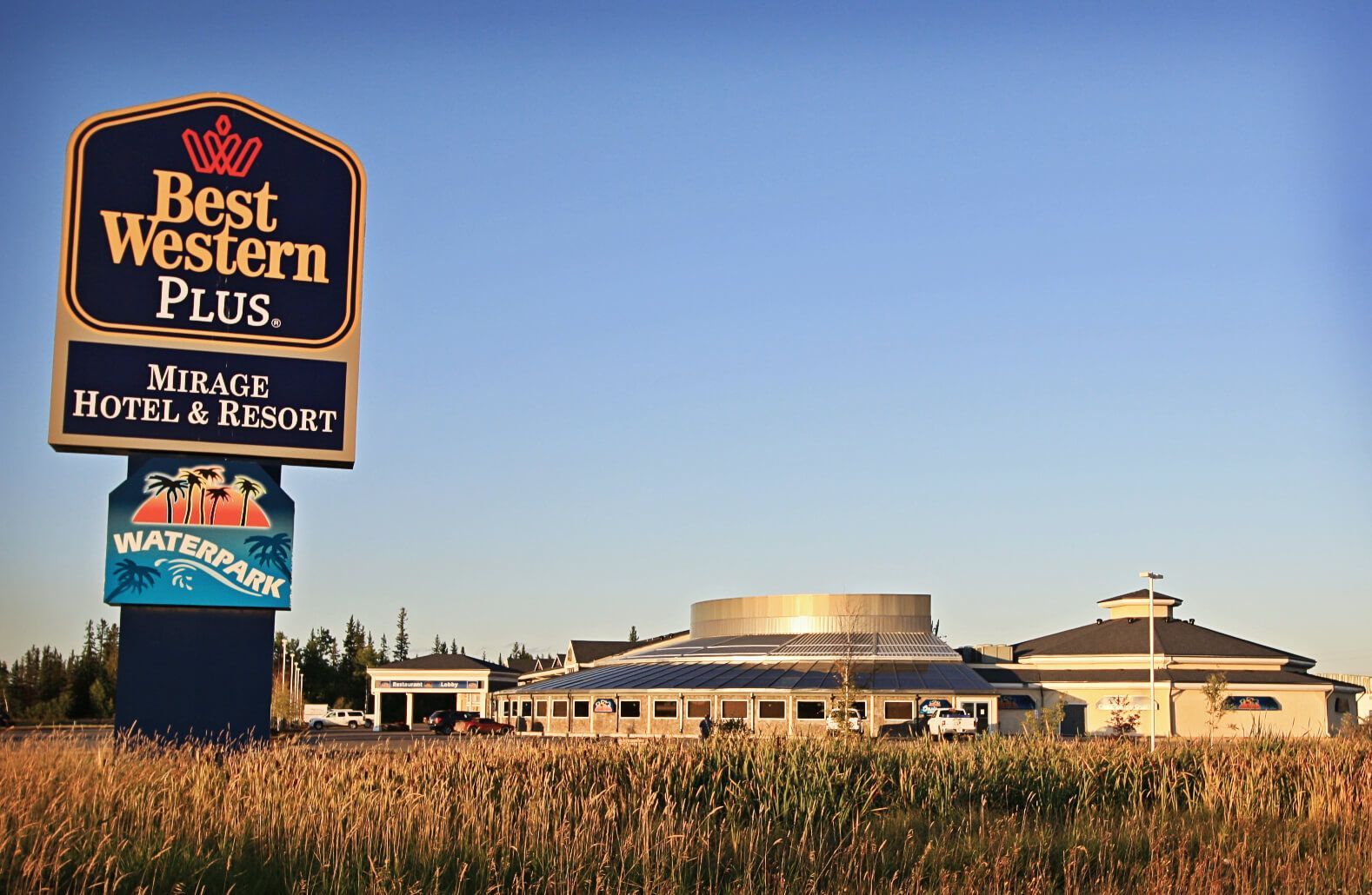 A sign for the best western plus hotel and resort