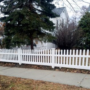 White picket fence in front of a house.