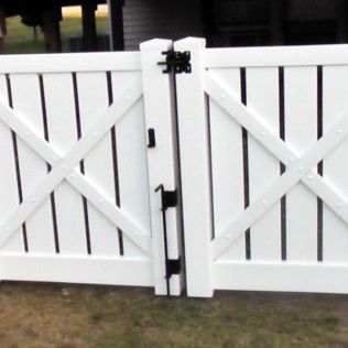White picket fence with gate, black hinges and latch.