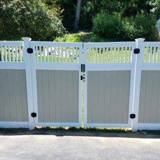 Tan and white vinyl fence with double gate.