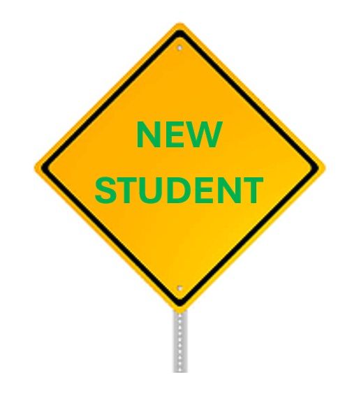 A young man is sitting in a car and smiling.