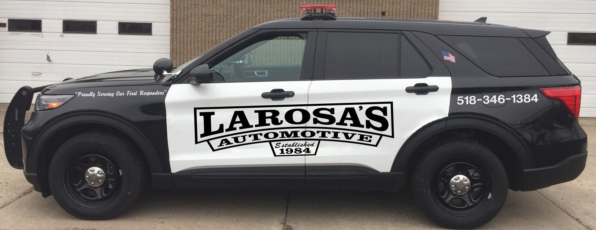 A black and white police car from larosa 's automotive