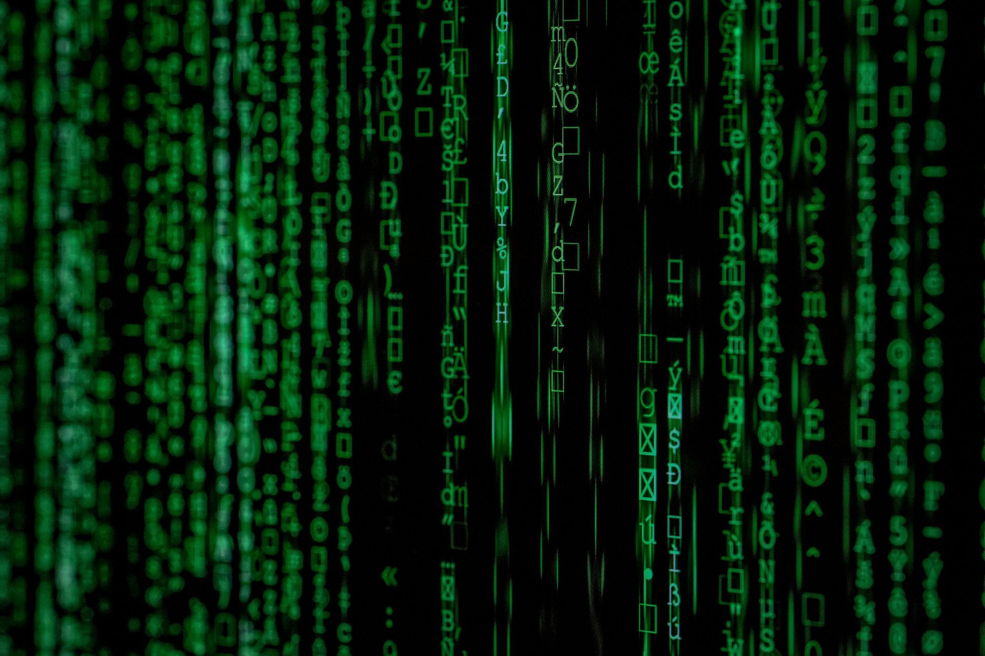 A close up of a green matrix background with numbers and symbols.