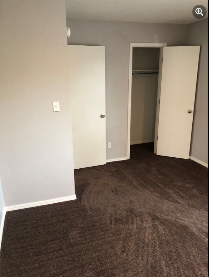 there is a closet in the corner of the room .