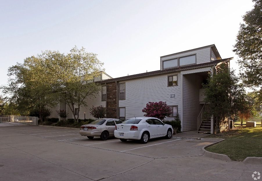 a white car is parked in front of a building