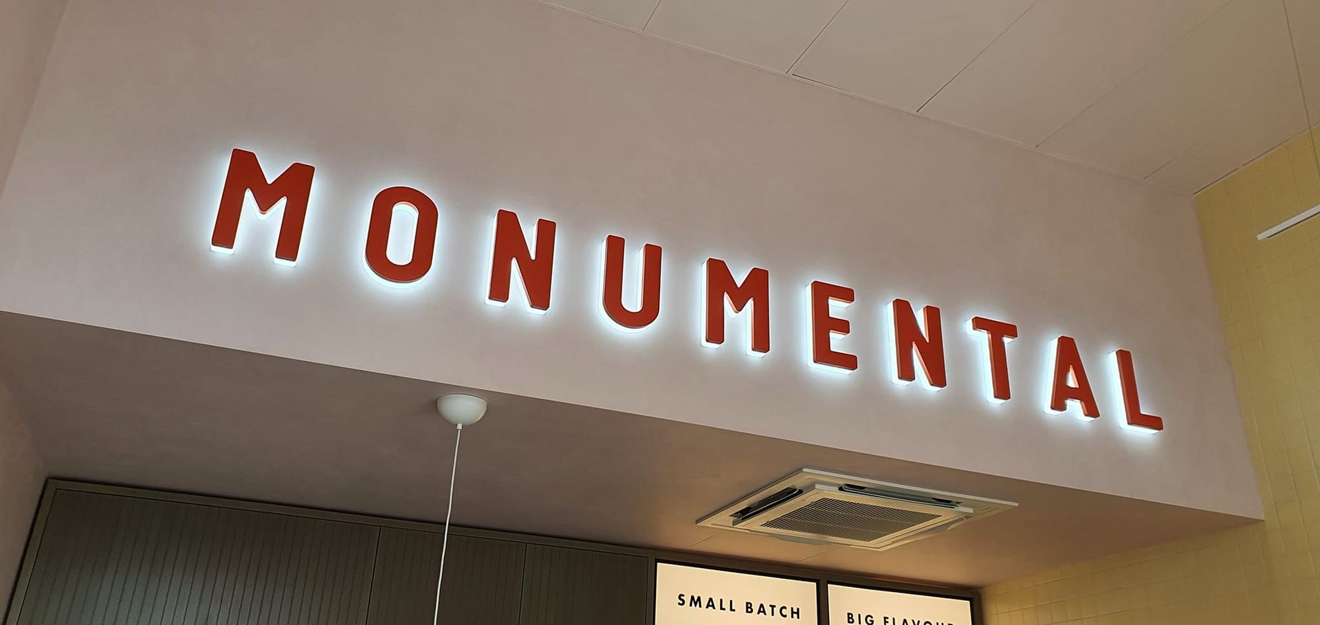 Sign Above a Doorway That Says Monumental — We Design & Manufacture Signage in the Albury-Wodonga, NSW