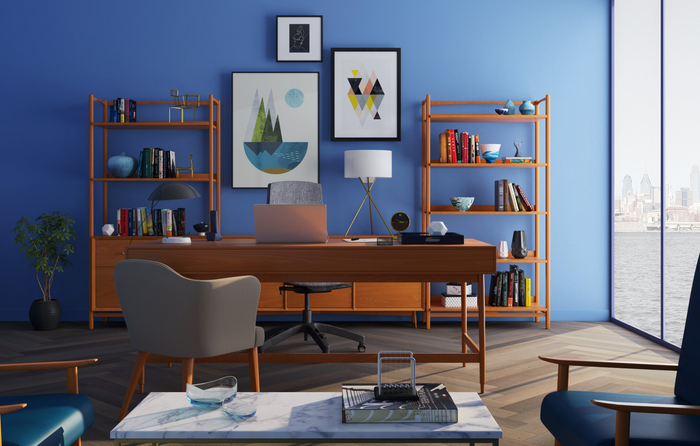 a home office with blue walls , a desk , chairs , shelves and a large window .