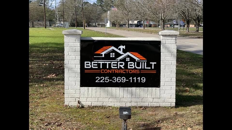 Sign for Better Built Contractors with logo, phone number, set in brick pillars.