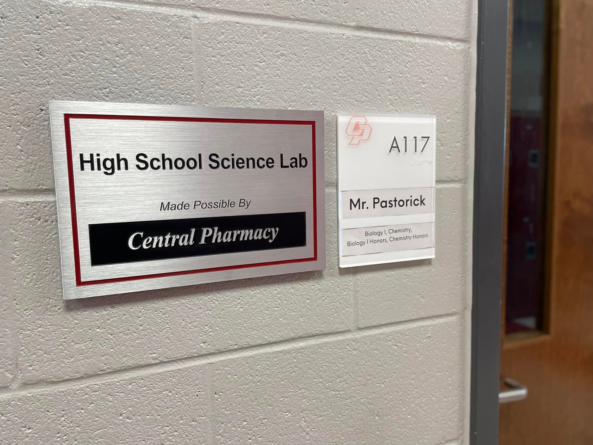 Sign for High School Science Lab, made possible by Central Pharmacy. Room A117, Mr. Pastrick.