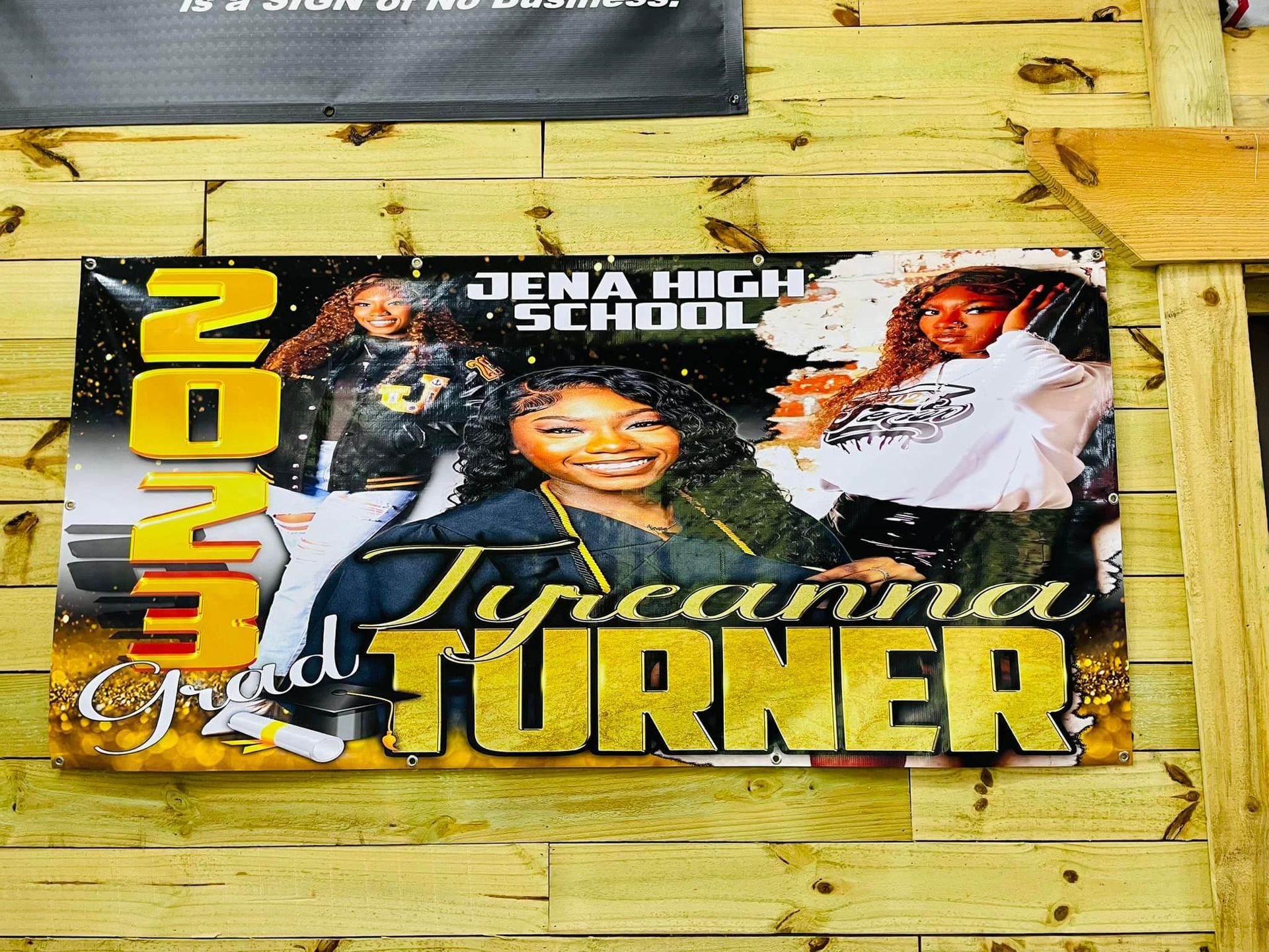 Banner: Jena High School graduate Tyreanna Turner, 2023. Three photos, gold lettering.