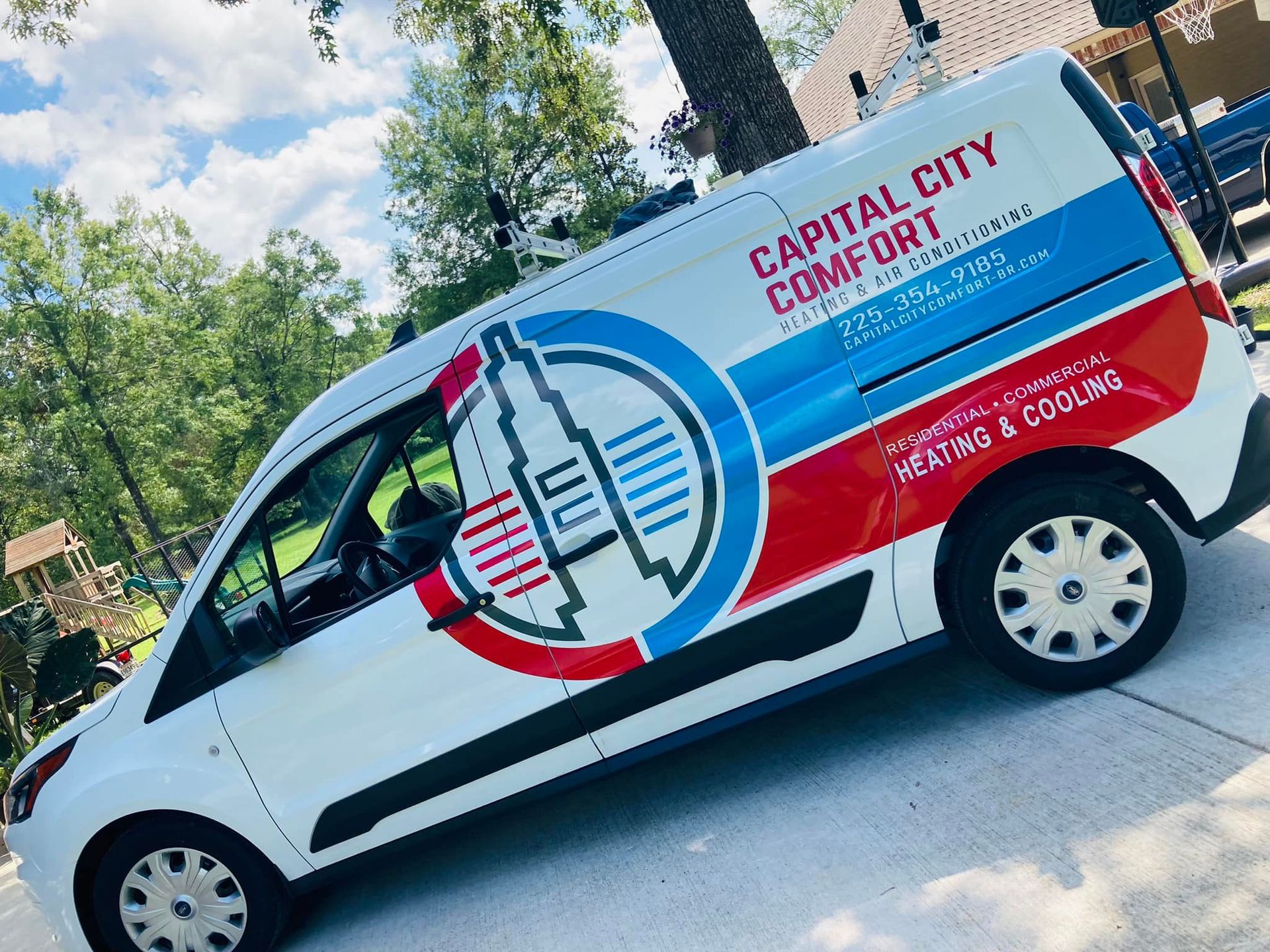 White bus parked on pavement; labeled 