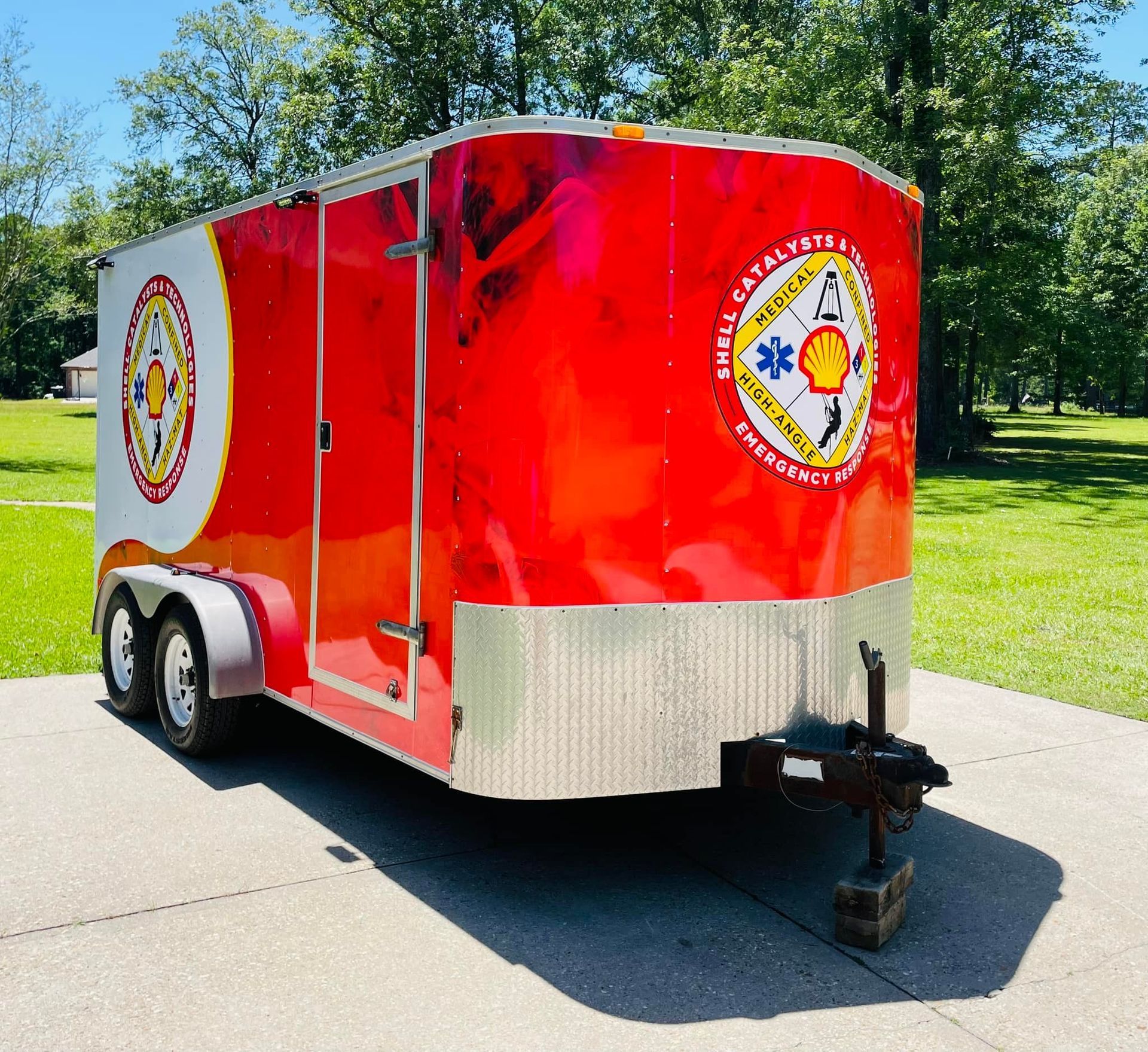 Red and white trailer with Shell Emergency Response logo parked outside.