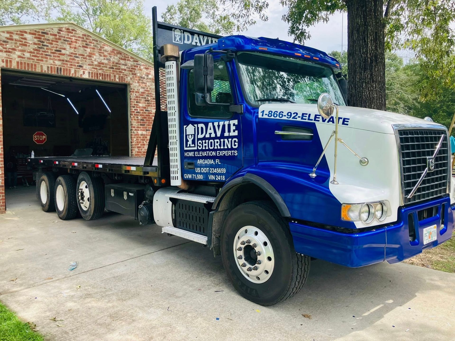 White bus parked on pavement; labeled 