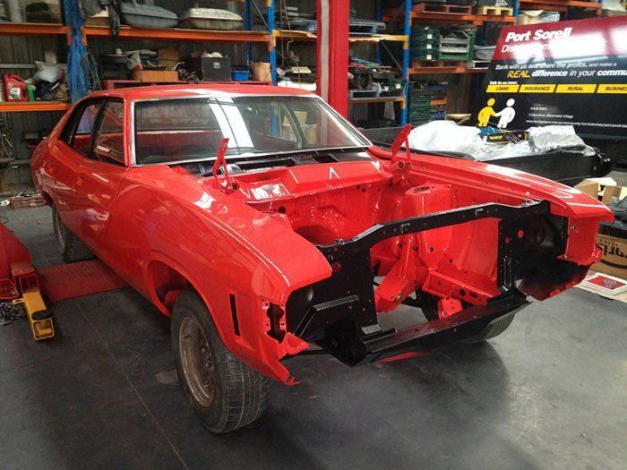 View of a red car during repair