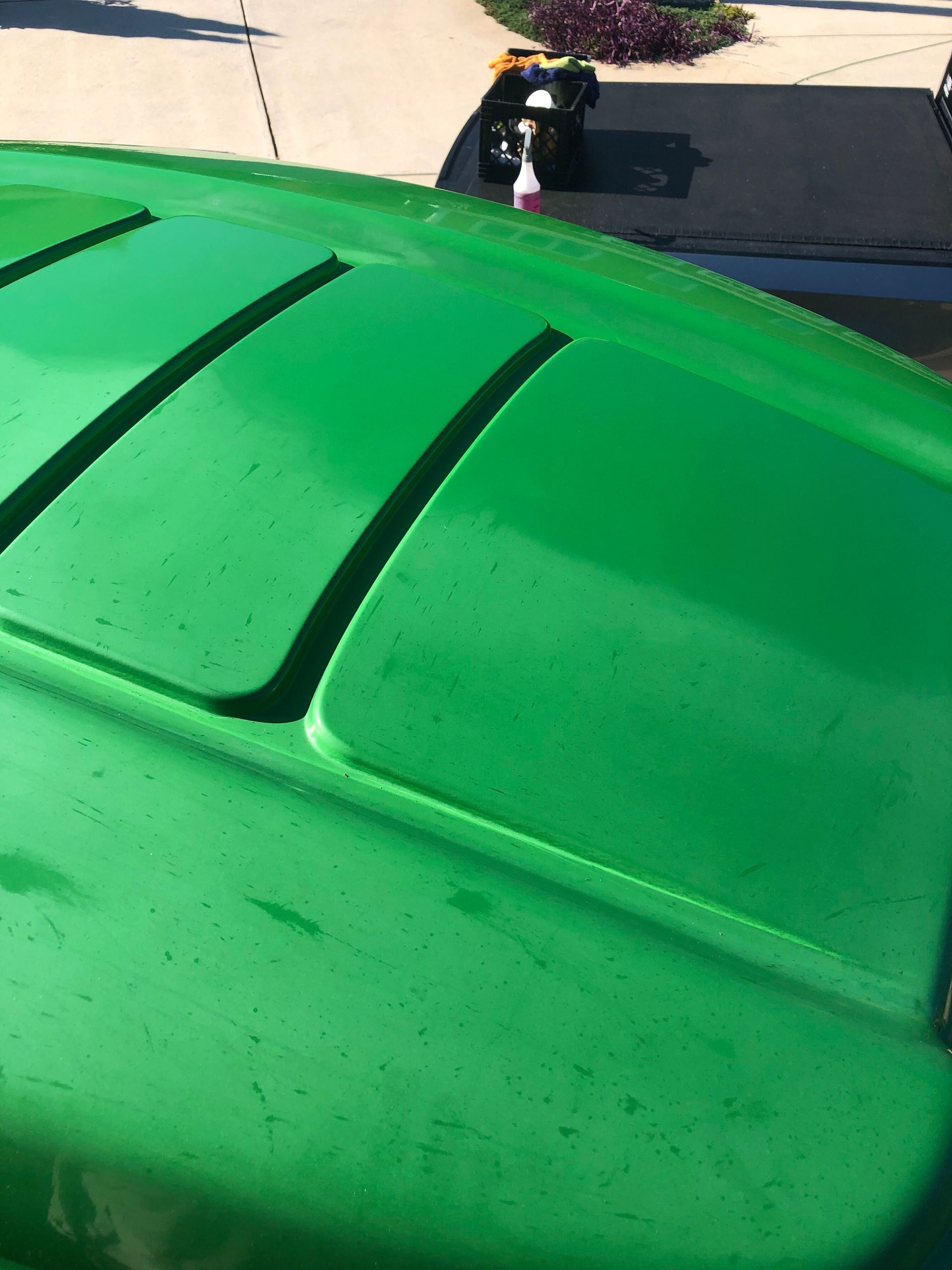 Green lawnmower hood with four horizontal vents.