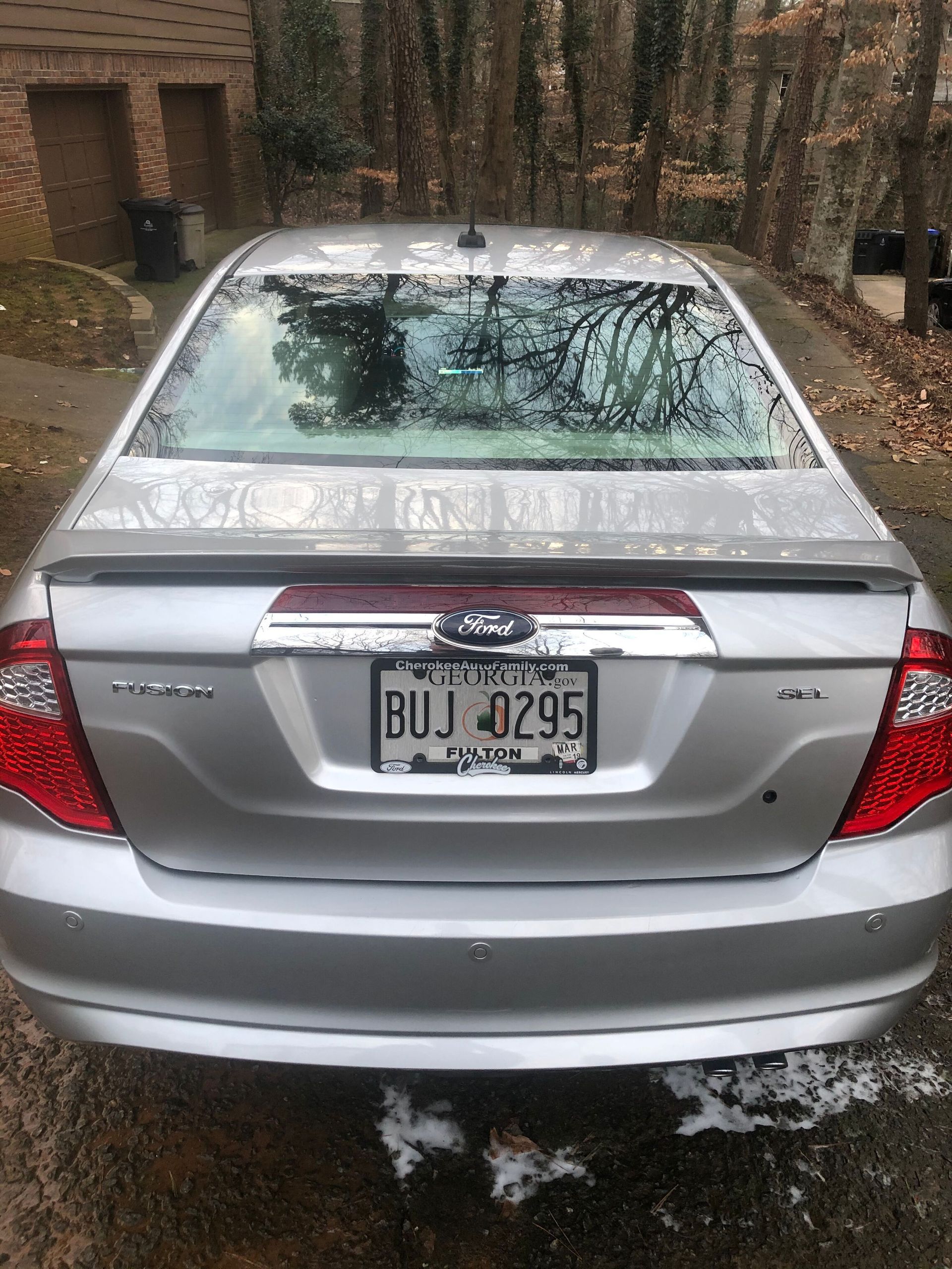 Silver Ford Fusion sedan, Ohio license plate, outdoors.