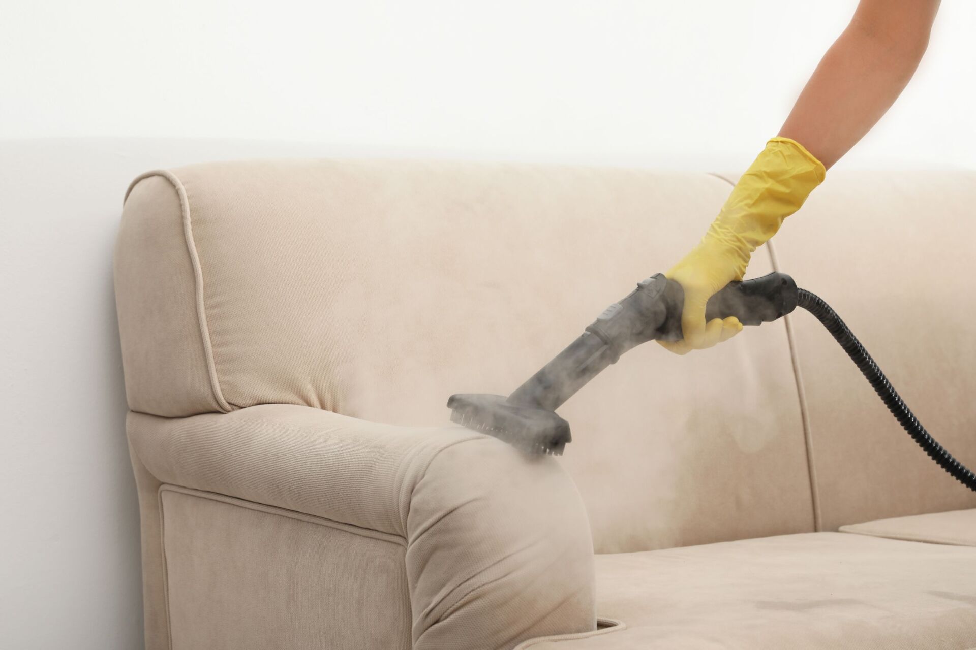 Removing Dirt From Sofa With Steam Cleaner — Pest Control & Carpet Cleaning Services in Hervey Bay, QLD