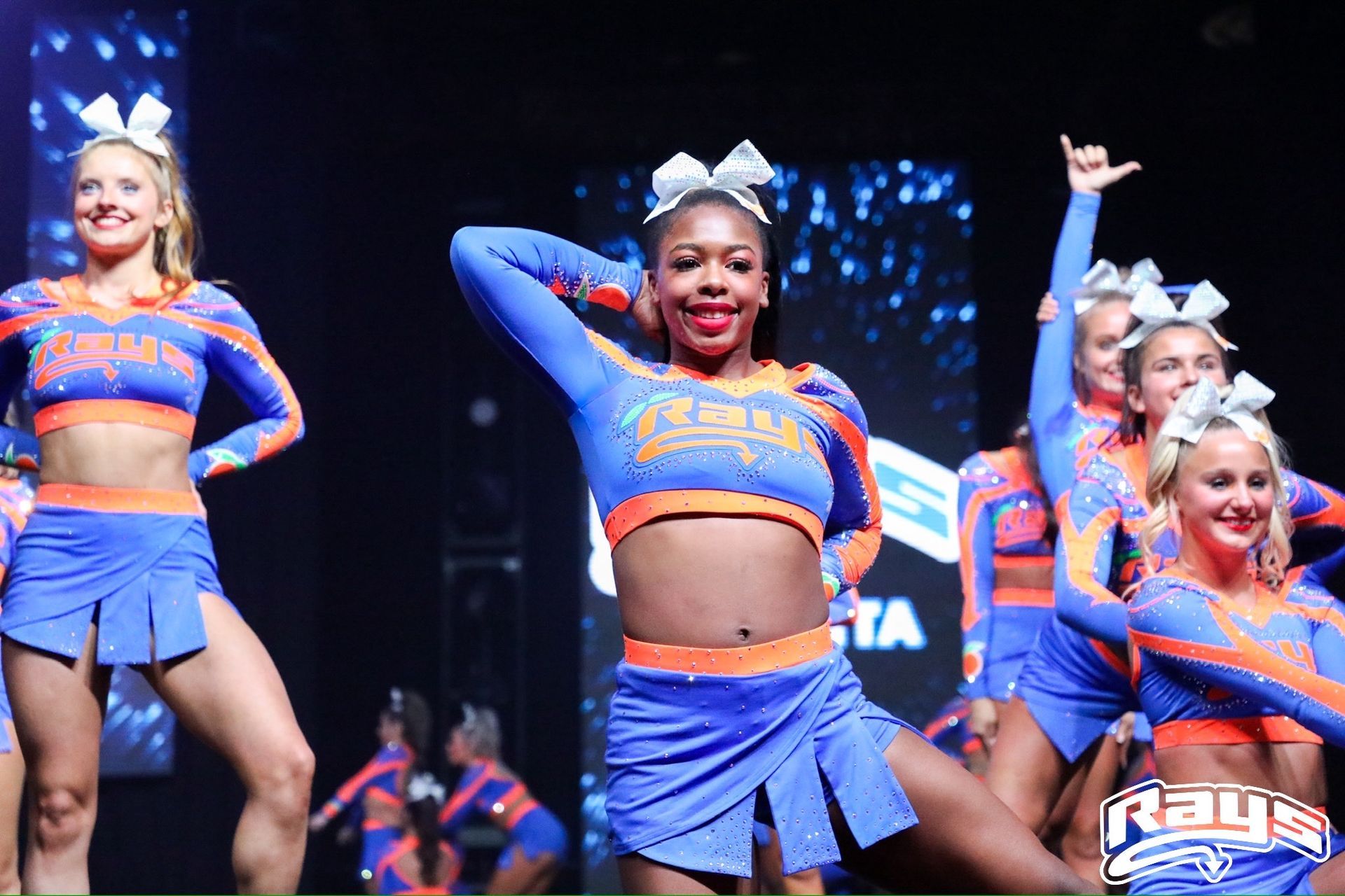 A group of cheerleaders are performing on a stage.