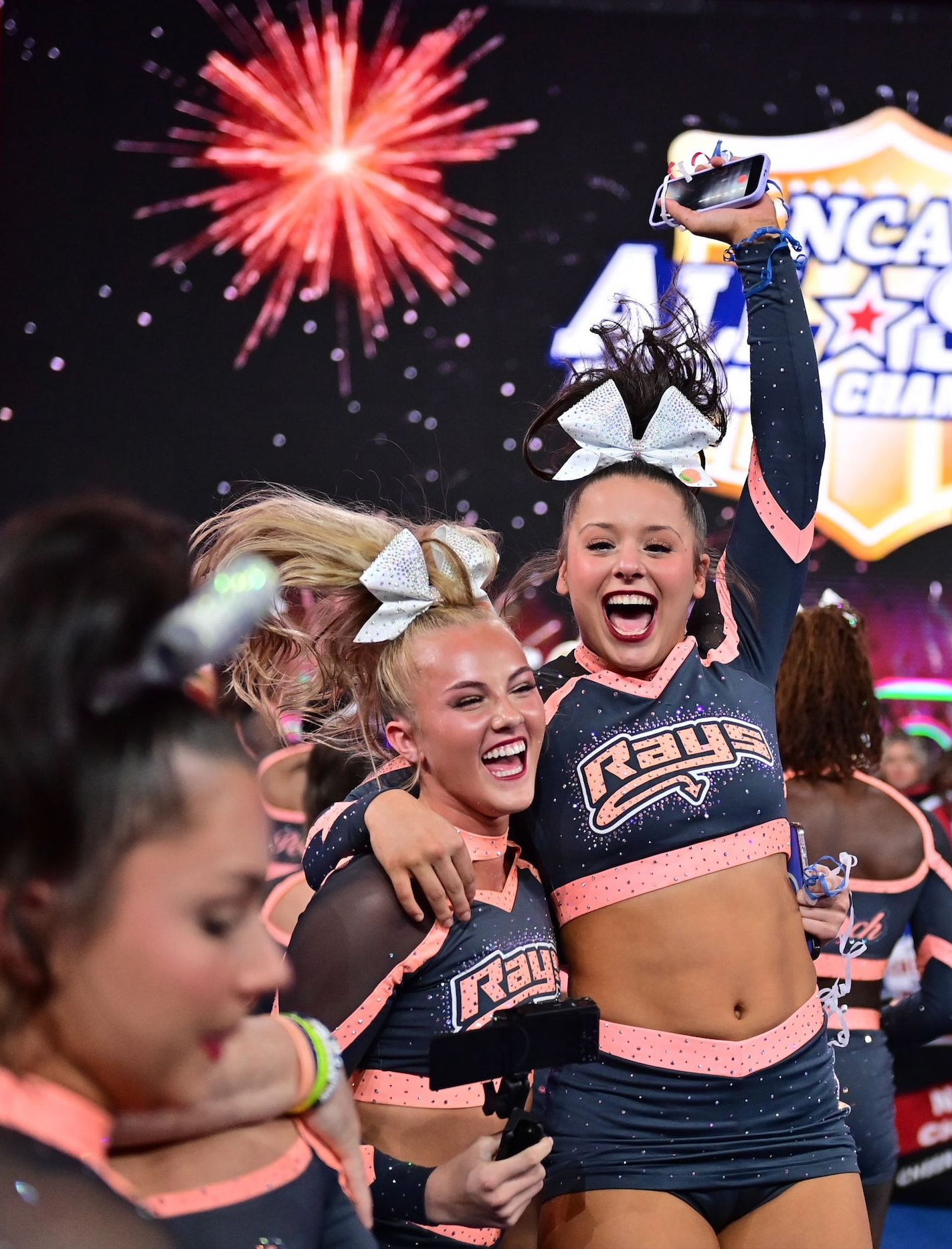 A boy and a girl are holding medals that say world champions