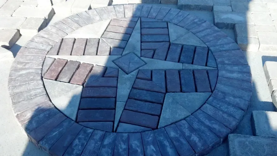 A circle of bricks with a cross in the middle