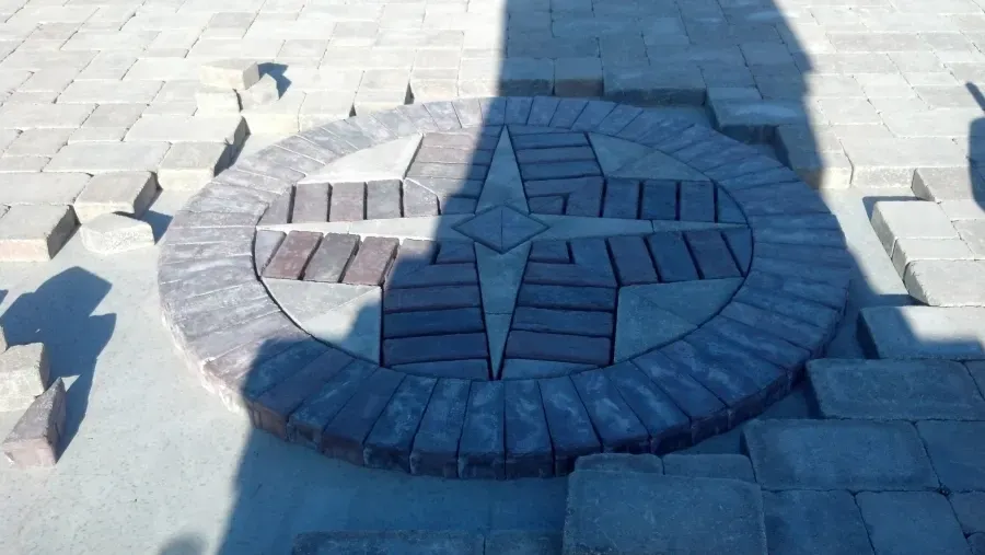 A circle of bricks with a compass on it