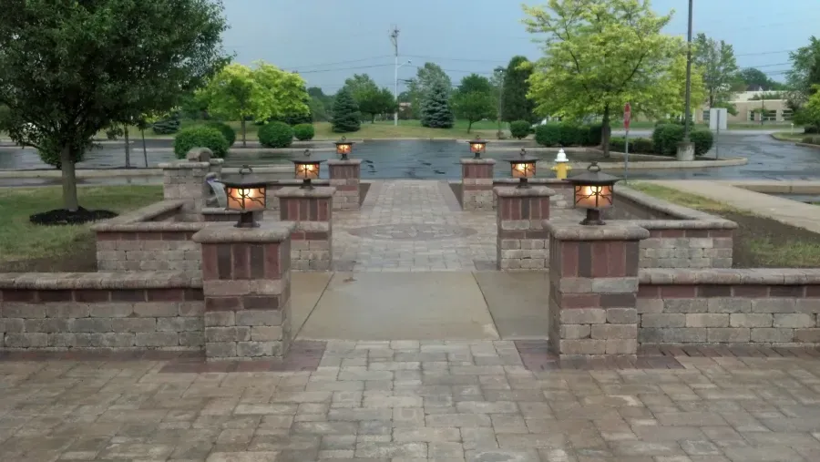 A brick walkway with a lot of lights on it