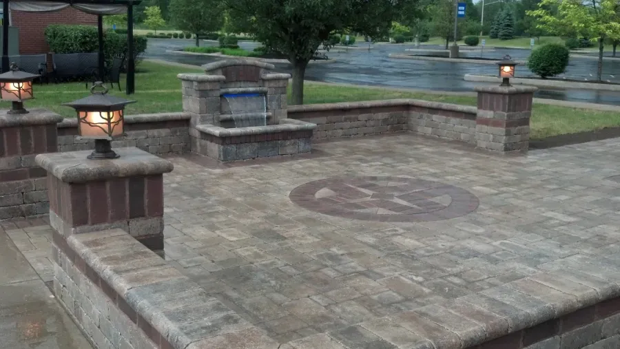 There is a fountain in the middle of the patio.