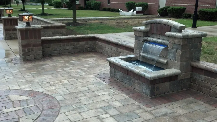 There is a waterfall in the middle of the patio.