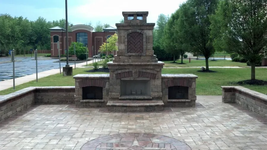 There is a fireplace in the middle of the patio.