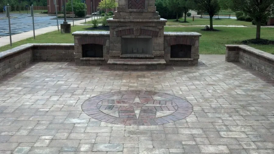 There is a fireplace in the middle of the patio.