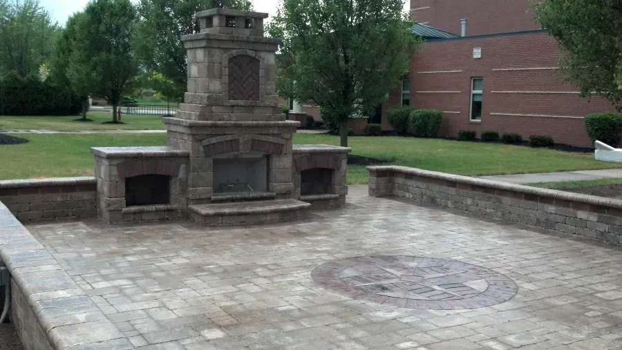 There is a fireplace in the middle of the patio.