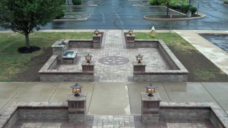 A brick walkway with a fire hydrant in the background