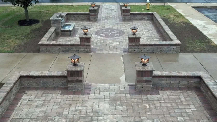 An aerial view of a brick patio with a walkway and lanterns