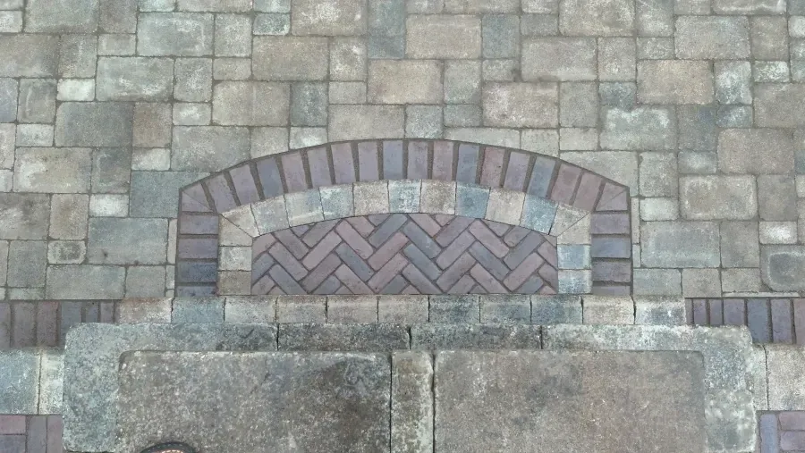 A brick wall with a herringbone pattern on it
