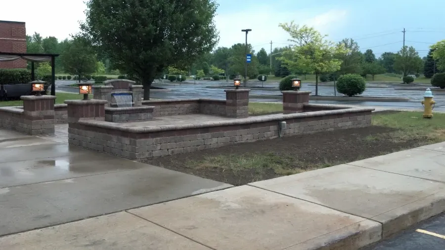 A fire hydrant is in the middle of a parking lot