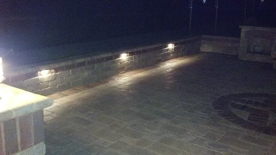A patio with lights on it at night.
