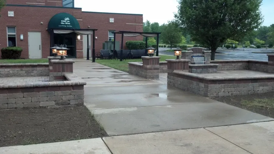 A brick building with a green awning over the entrance