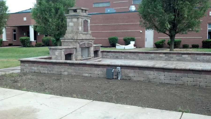 A brick fireplace in front of a brick building
