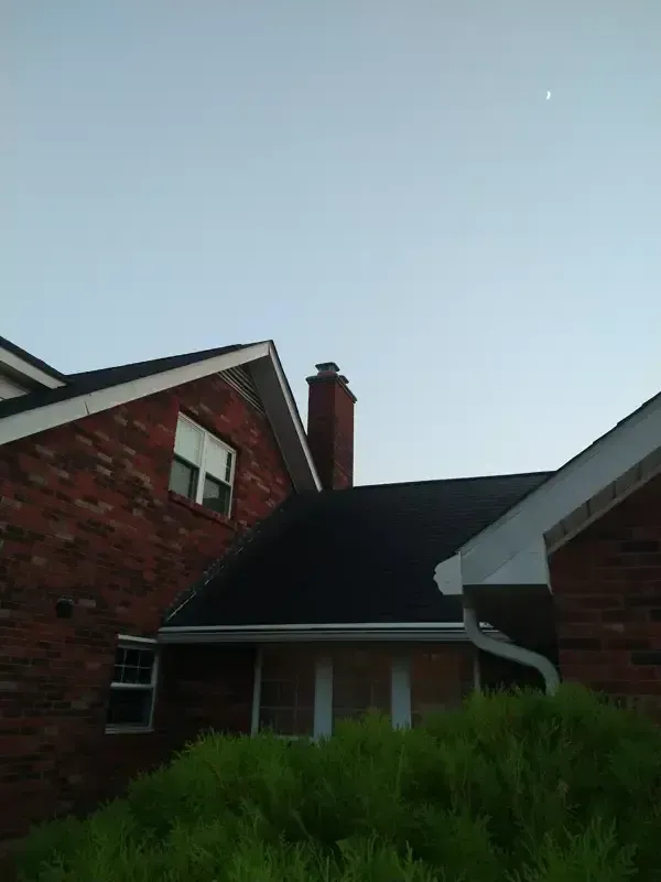 A brick house with a chimney on the roof