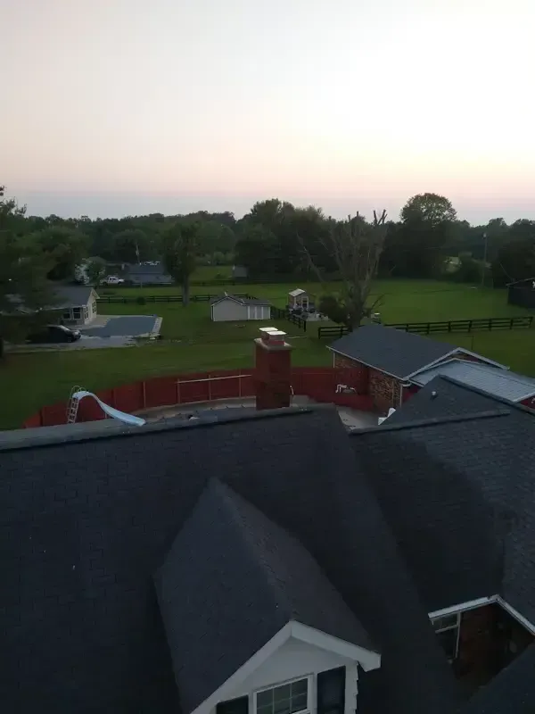 An aerial view of a house with a chimney on the roof