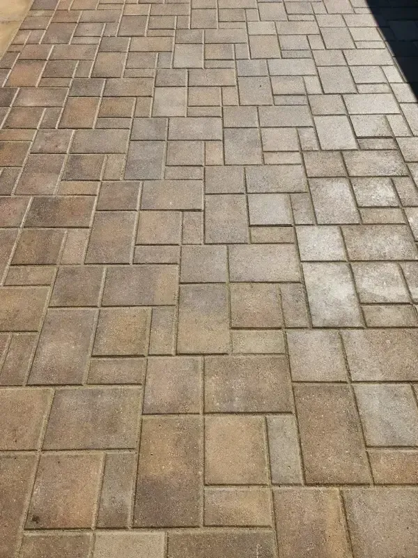 A brick walkway with a pattern of squares on it