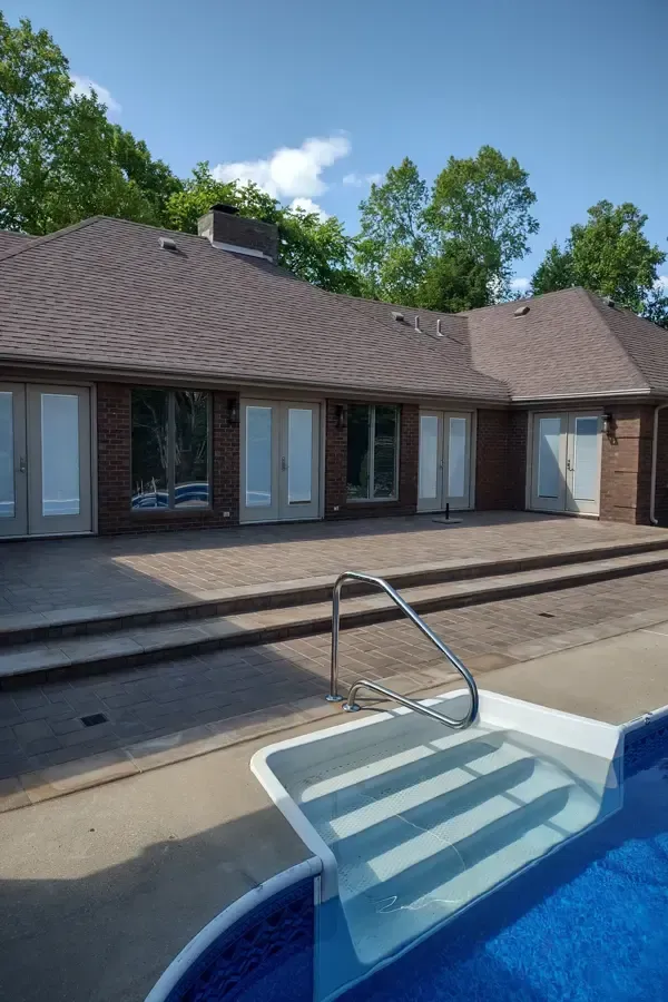 A house with a swimming pool in front of it