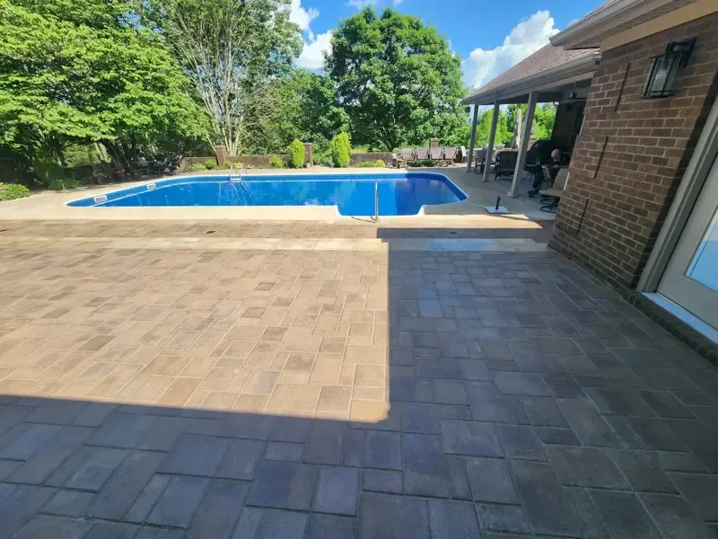 A brick house with a large swimming pool in the backyard