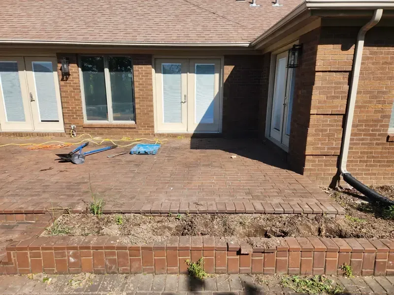 A brick house with a patio in front of it