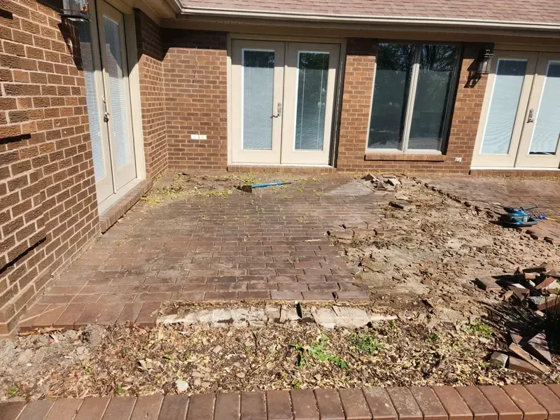 A brick house with a patio in front of it.